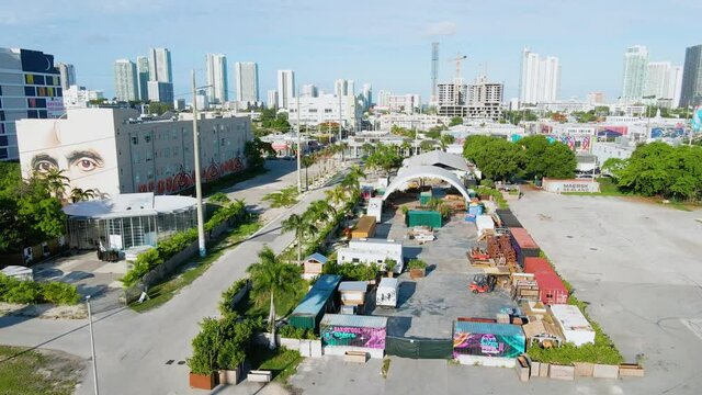 Aerial view over streets of the Wynwood district, towards Skyscaper in Miami, Florida, sunny day, in USA  - rising, drone shot