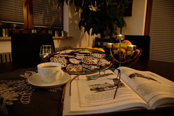 Christmas gingerbread and fruits on the table with candles