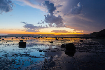 Silhouette of beach reef at dusk.