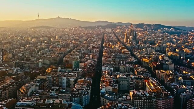 Drone flight over the streets of Barcelona at sunset, Spain. 
