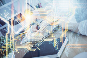 Double exposure of hands making notes with world map hologram and data theme icons. Concept of international network data.
