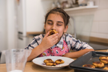 Little girl's hands holding a freshly baked cookie.