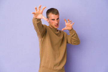 Young caucasian handsome man upset screaming with tense hands.