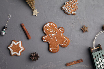 Christmas holidays ornament flat lay; Christmas card background. Gingerbread cookie, christmas toys on gray background