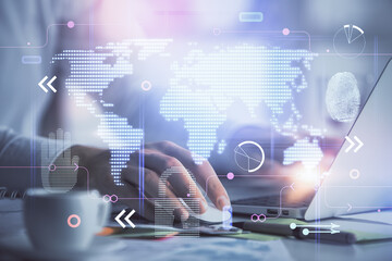Multi exposure of world map hologram with man working on computer on background. Concept of worldwideweb.