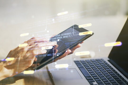 Double exposure of abstract programming language hologram with finger clicks on a digital tablet on background, research and development concept