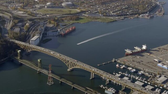 Vehicles Driving At Iron Workers Memorial Bridge Next To Second Narrows Rail Bridge Over Burrard Inlet In Vancouver, British Columbia, Canada. - aerial