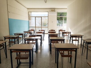 Empty classroom with desks without pupils due to covid-19