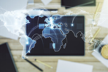 Abstract graphic digital world map with connections and modern digital tablet on desktop on...