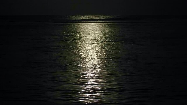 Moon light on dark waves near beach