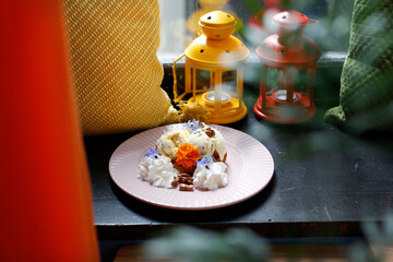 Ice cream with nuts and raisins and whipped cream.
Culinary photography. Food styling.