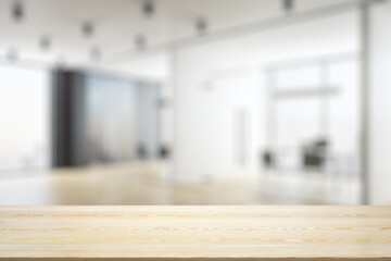Empty tabletop made of wooden dies with light furnished office on background, template