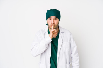 Young surgeon man isolated on white background keeping a secret or asking for silence.