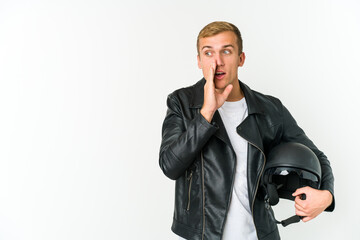 Young caucasian man holding a motorbike helmet isolated on white background