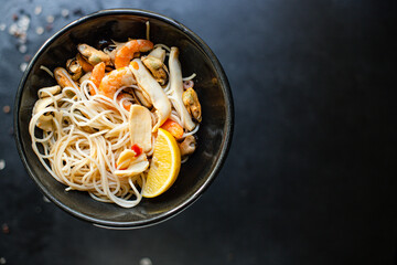 rice noodles cellophane pasta seafood shrimp, mussels, squid healthy meal snack top view copy space for text food background rustic