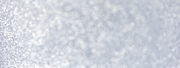 Christmas glittering Silver Background. Christmas lights. Blurred Xmas Bokeh as a Greeting card