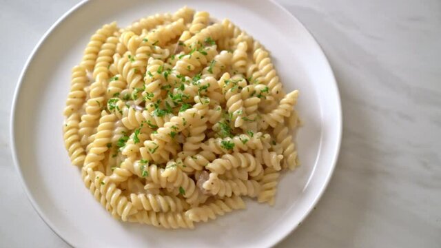 spirali or spiral pasta mushroom cream sauce with parsley - Italian food style