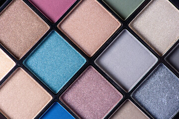 Palette of different beautiful colors of eye shadow closeup. Macro photography of makeup cosmetics