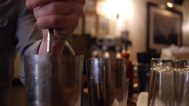 Bartender Pours Three Liquors From Bottle Into Tin Cocktail Shakers