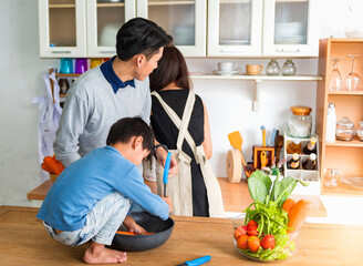 Cooking Family. Chef parent and kid boy make fresh vegetables salad for healthy eat. Asian son helping make food, so happy and enjoy. Family Lifestyle Concept