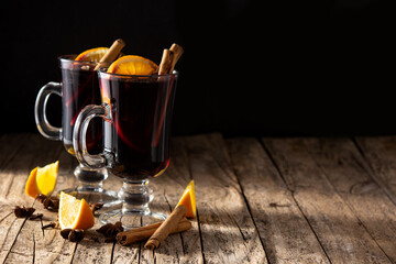 Traditional mulled wine with spices on wooden table.Copy space
