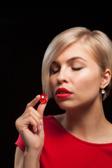 Young woman with red dice on black