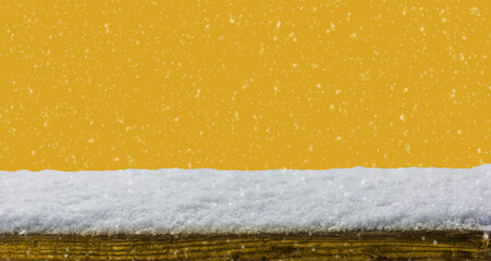 Empty wooden table snow covered with snowfall isolated on Fortuna Gold color background
