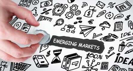 Technology, Internet and network concept. Young businessman shows the word: Emerging markets