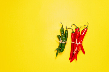 Red and green chili peppers, shot from above with a place for text. on yellow background