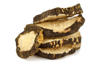 Black Maca Composition. Peruvian Ginseng Dry Root Slices (Lepidium Meyenii). Isolated on White.