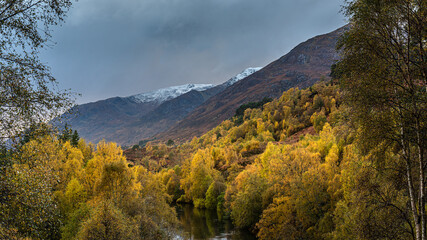 Dramatic skies, Autumn colours and snow in Glen Affric in the Scottish Highlands