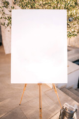 Wooden easel with white paper