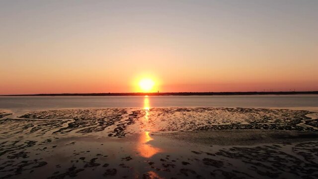 Stunning Clear Orange Sunset Over Tidal Flat Of North Sea In Germany Near Husum