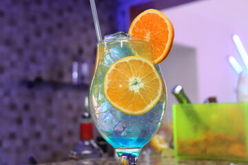 a blue lagoon drink decorated with orange slices