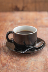 A cup of coffee over a wooden rustic table