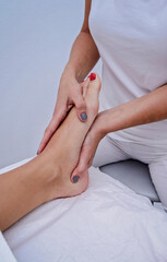 Woman having massage on her feet at spa salon.