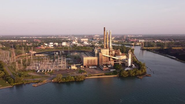 DTE Electric Company Rouge River Coal Power Plant From River In Michigan, USA. - aerial ascend