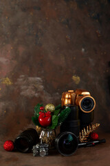 christmas and new year background for photographer. christmas set gold camera and lenses and christmas tree toys on dark background vertical orientation