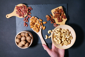 wooden bowl with mixed nuts. Healthy food and snack. Walnut, peanuts, almonds, hazelnut and cashews.