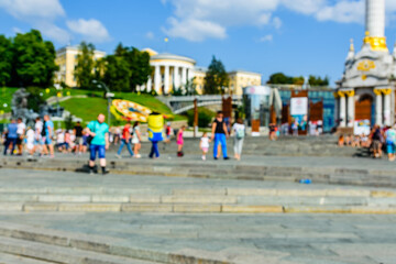 Defocused blurred background of the city street and people silhouettes