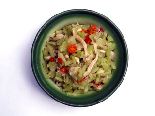 Spicy stir fried chayote or tumis labu siam is typical Indonesian home dish. Made from slices of chayote, seasoning with garlic and onion. Some love to add mushroom. Serve in enamel bowl. Isolated.