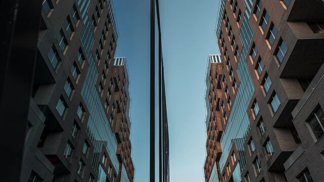Architecturally Diverse Building Of DnB NOR With Mirror Reflection At Barcode Project In Downtown Oslo During Sunset - low angle, time lapse