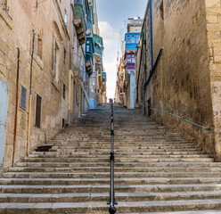 Flight of old stone steps in Valletta the capital of the Island of Malta. - 395301840