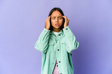 Young mixed race woman touching temples and having headache.