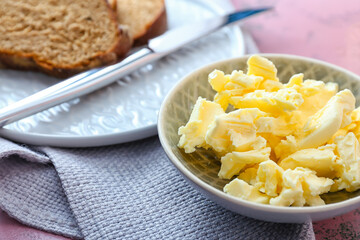Plate with fresh butter on table