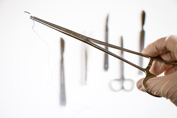 Surgery operation equipment, knife, needle and suture. Studio shoot.