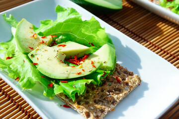 Avocado sandwich with avocado crisp bread for snack. Fiber, fitness and diet food.