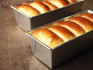 Milk bread in baking loaf tin