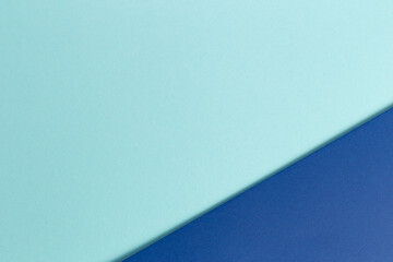 Material design blue background. Craft paper sheets are folded in different ways. A photo.