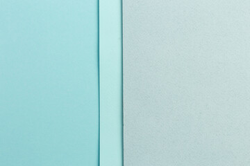 Material design blue background. Craft paper sheets are folded in different ways. A photo.